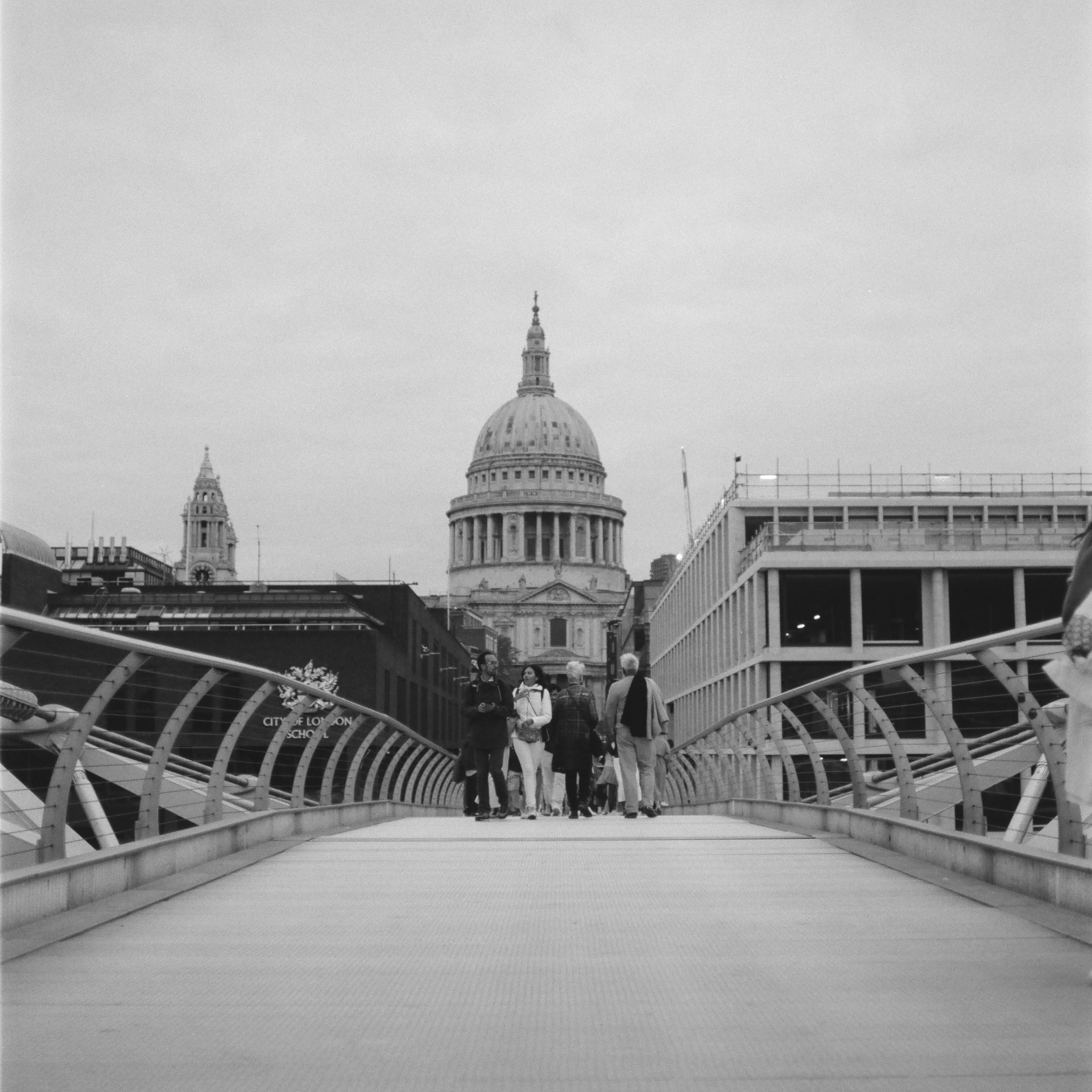 middle of a pedestrian bridge with St. Paul's Cathedral in the background