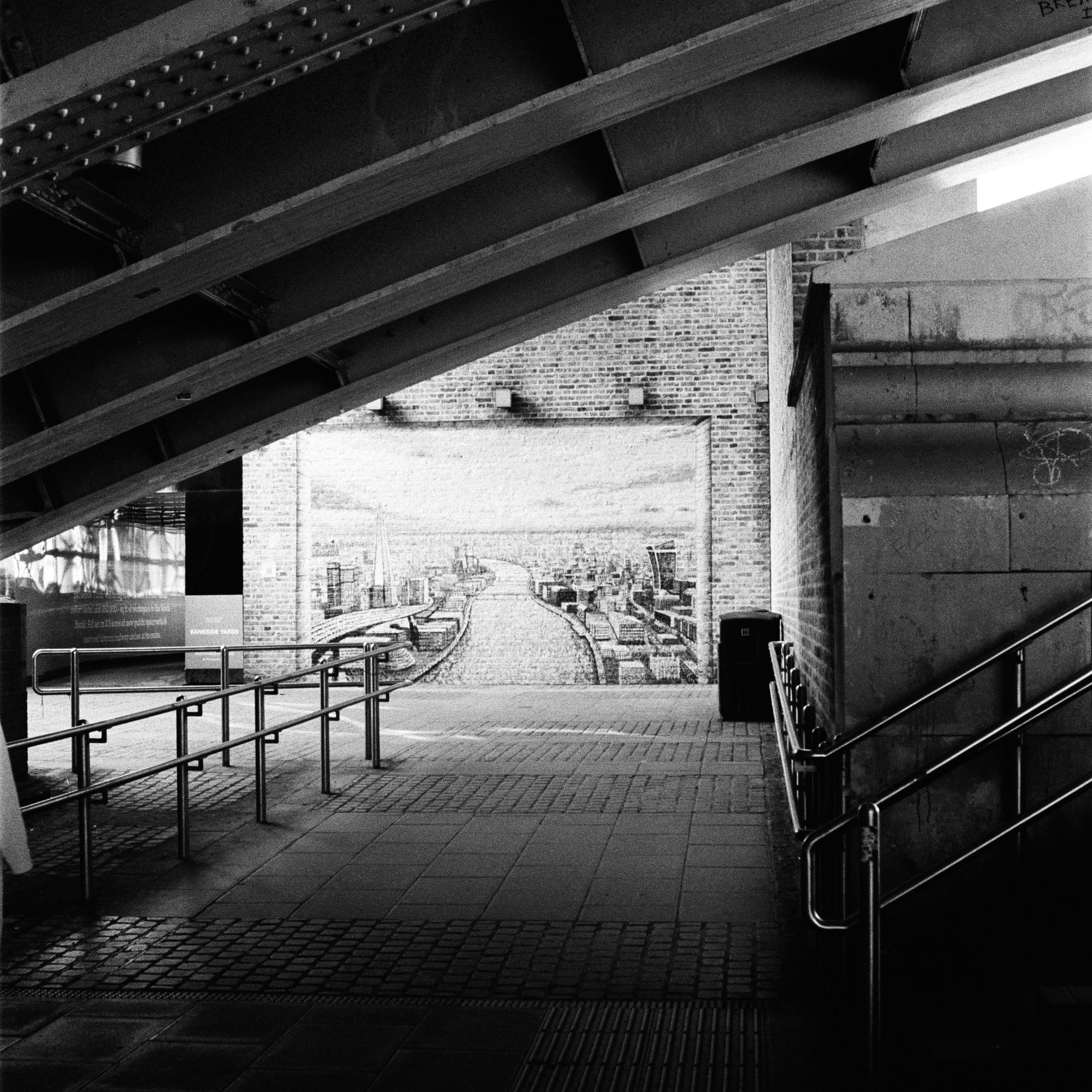 bridge underpass, on which a wall mosaic is visible at the end