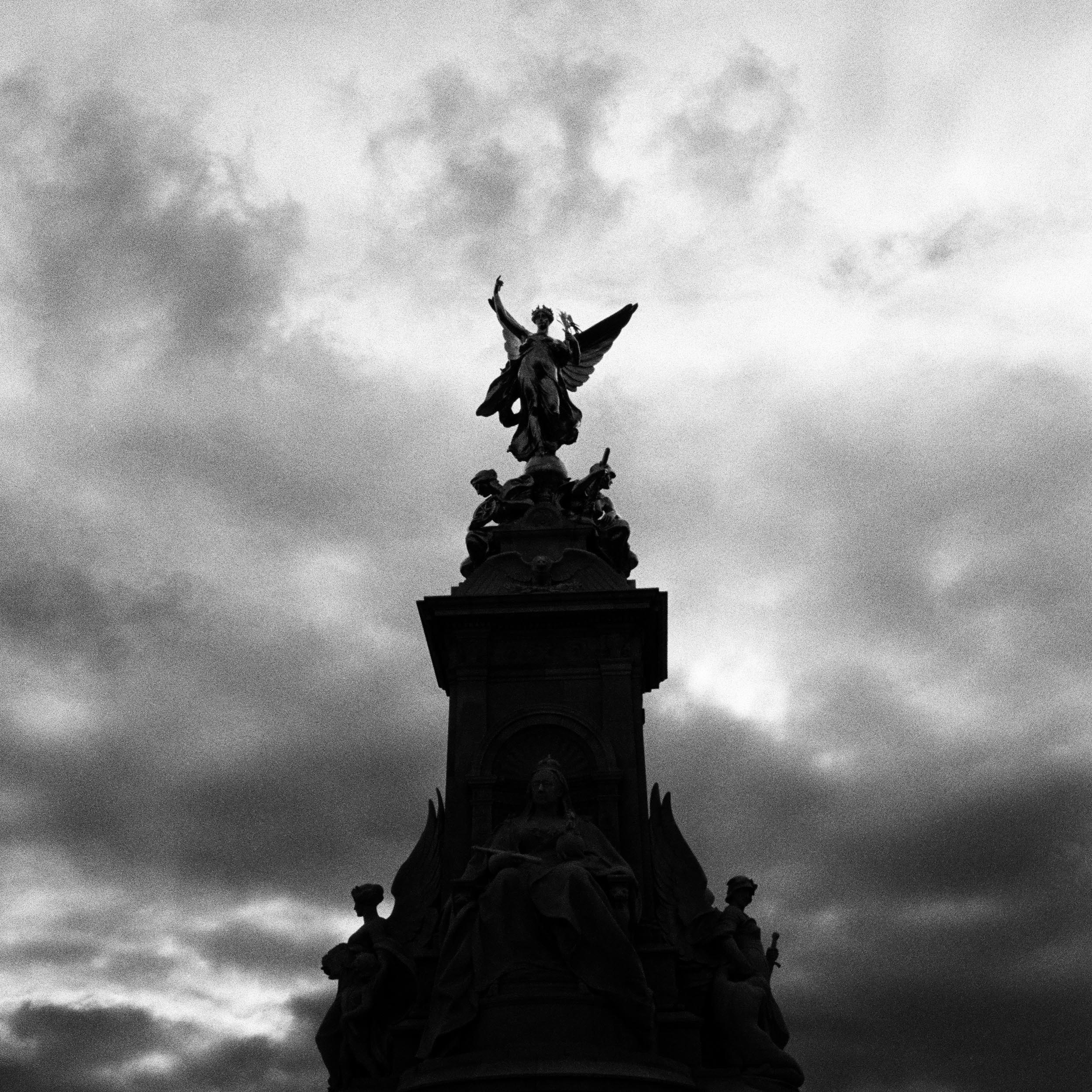 statue of women with wings on top of a fountain
