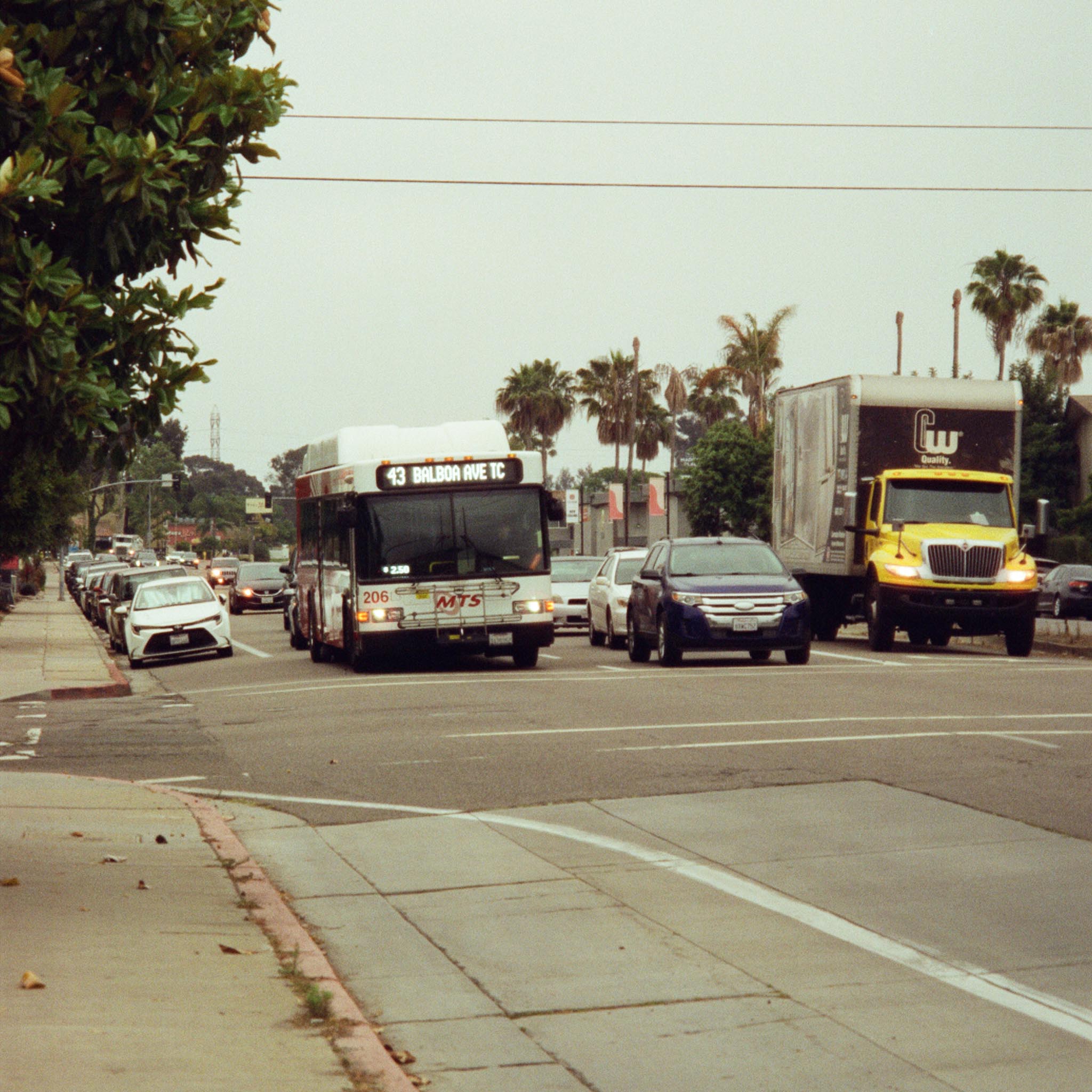 road crossing with an approaching public transport vehicle and other traffic