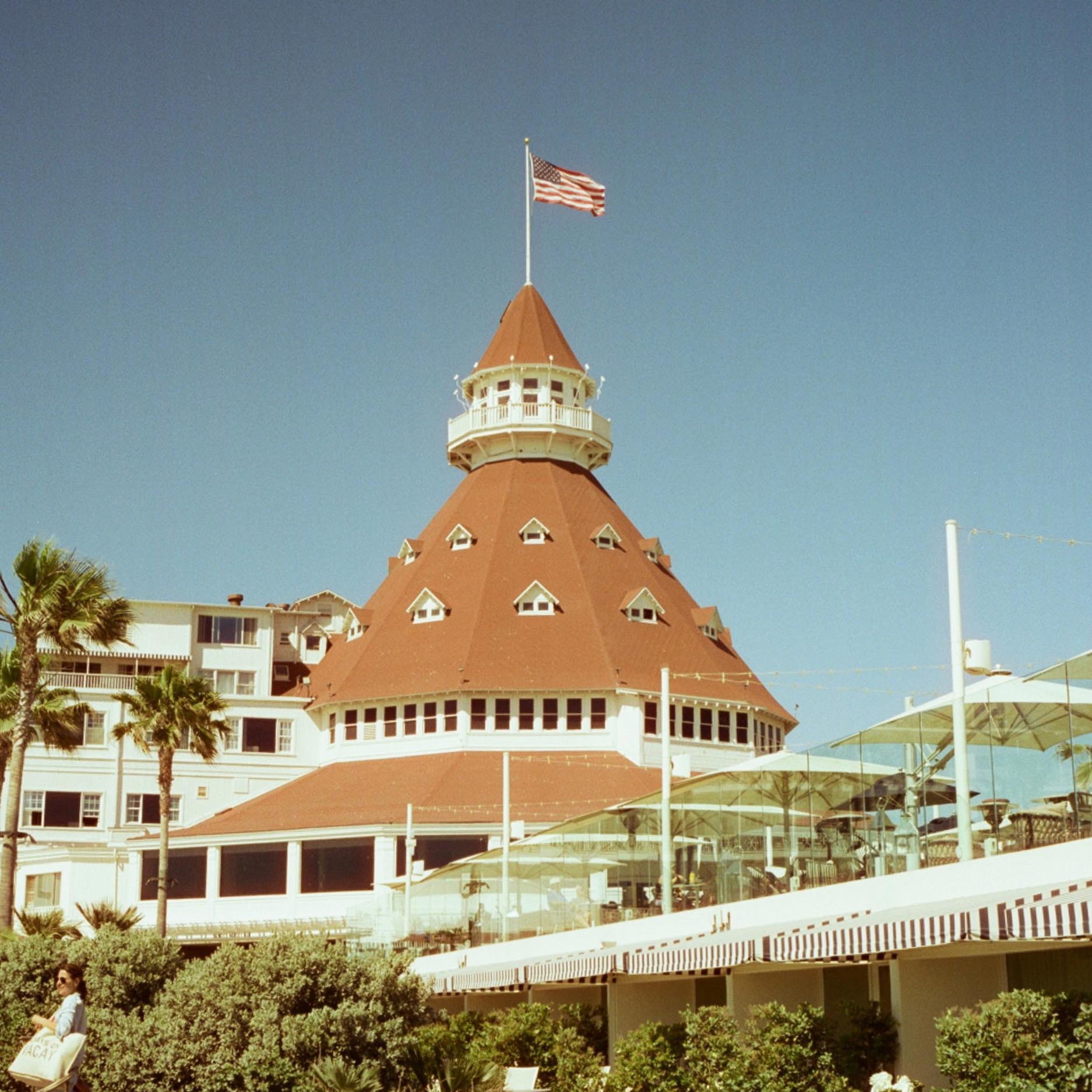 famous beach hotel with cone shaped roof and american flag at the top