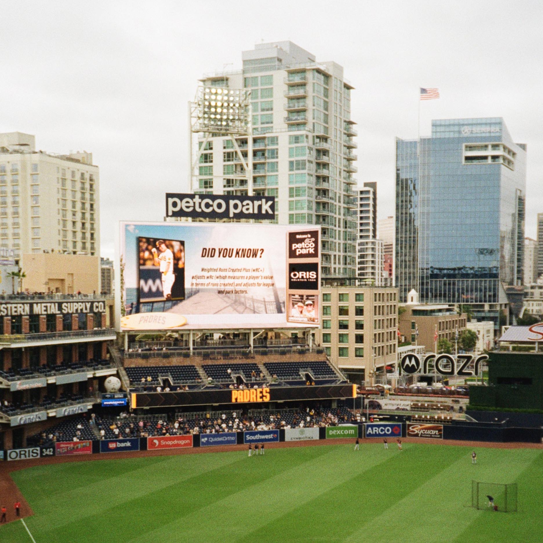 baseball stadium with the playing field in the foreground and the city skyline in the background