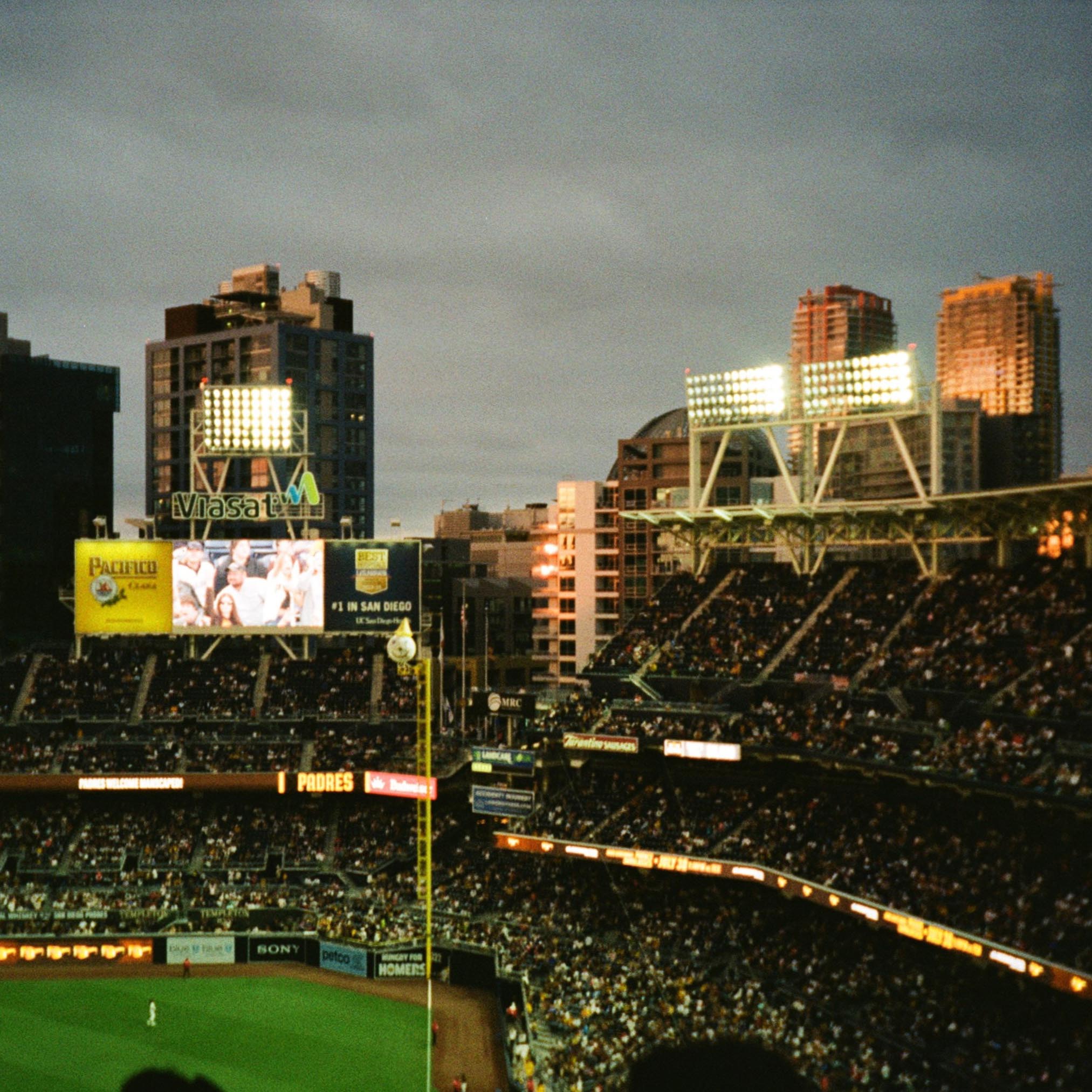 completely filled baseball stadium at dusk