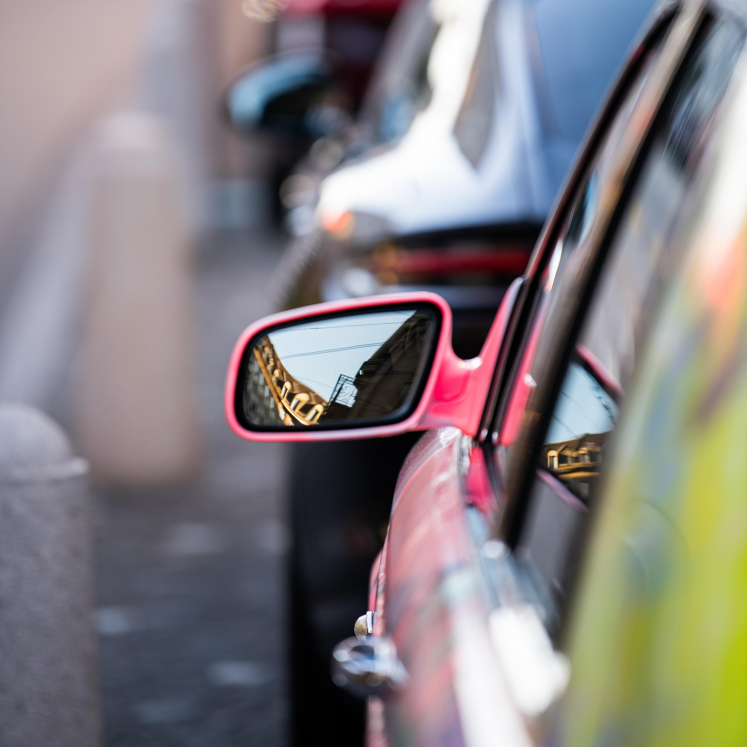 reflection of a city in a car side mirror
