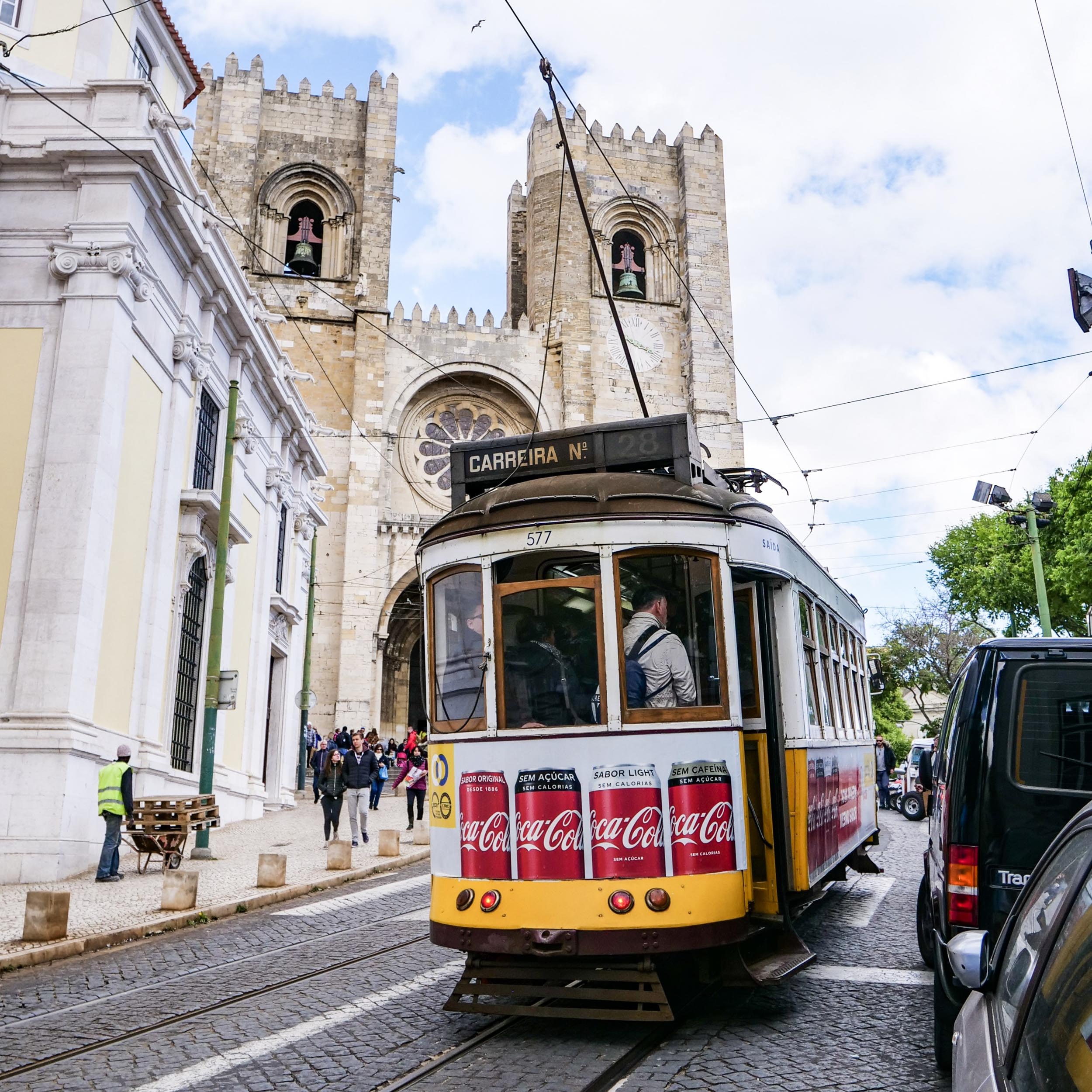 streetcar going up a hill in front of a church