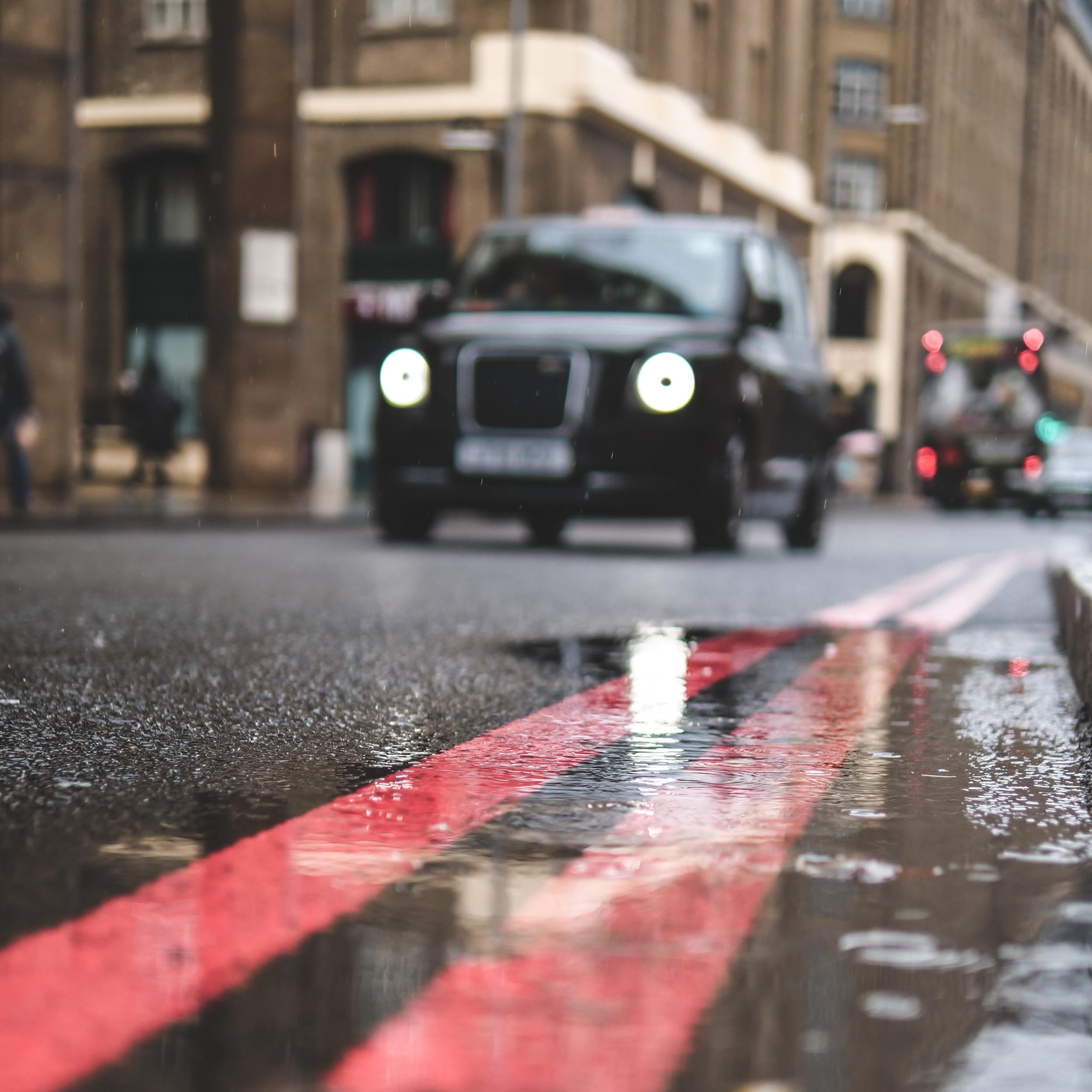 rainy road with approaching cab