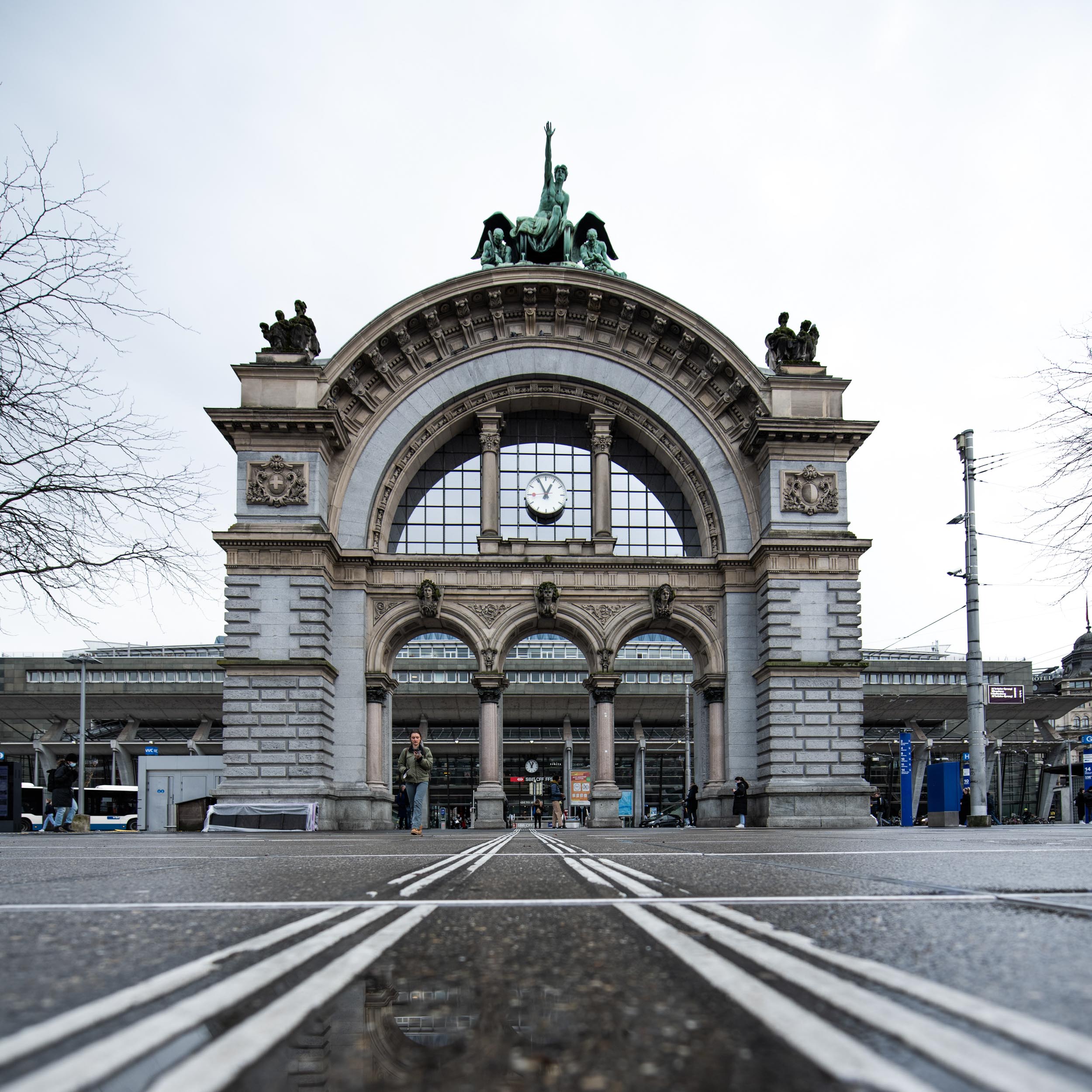 ancient-looking monument in front of a train station