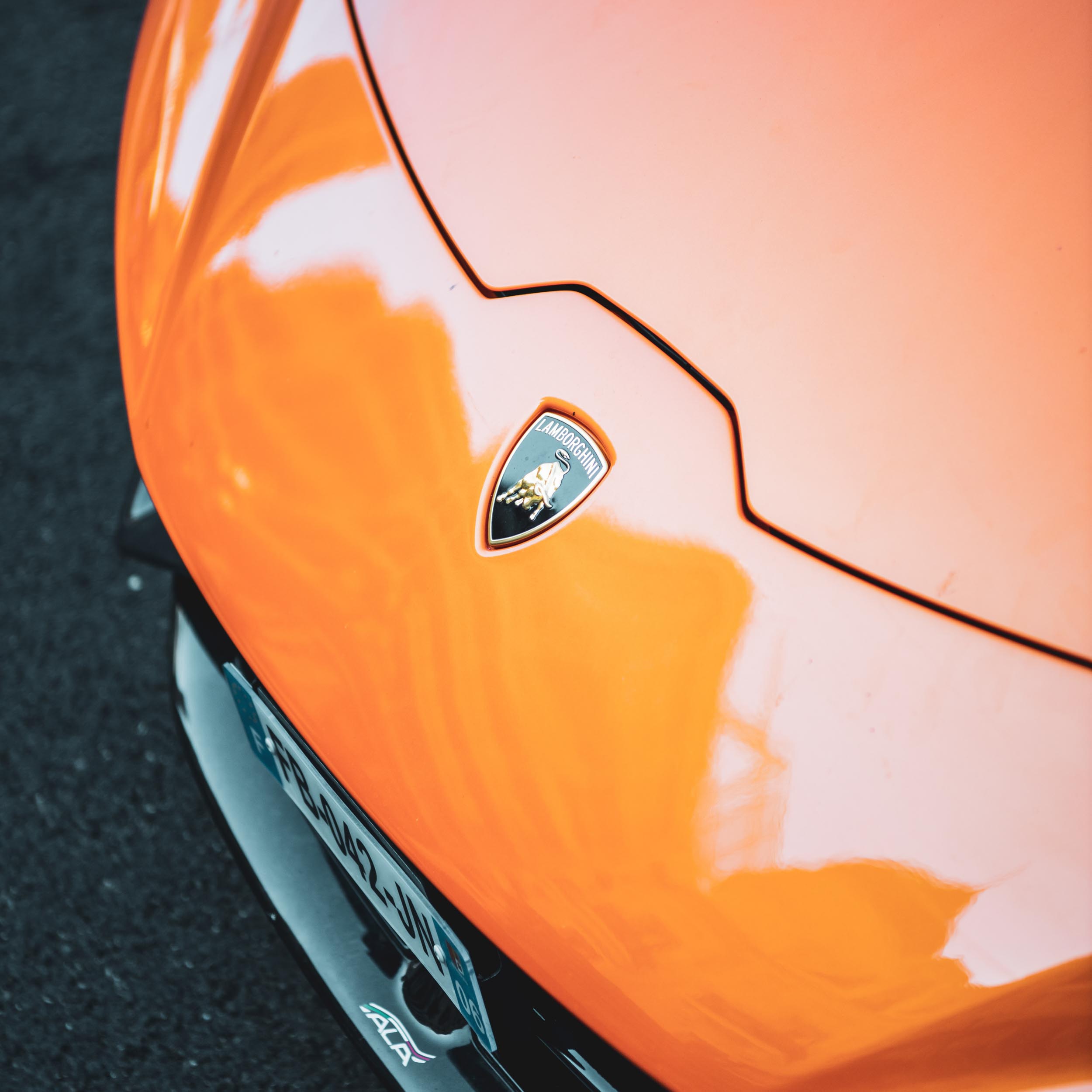 front logo of an orange Lamborghini