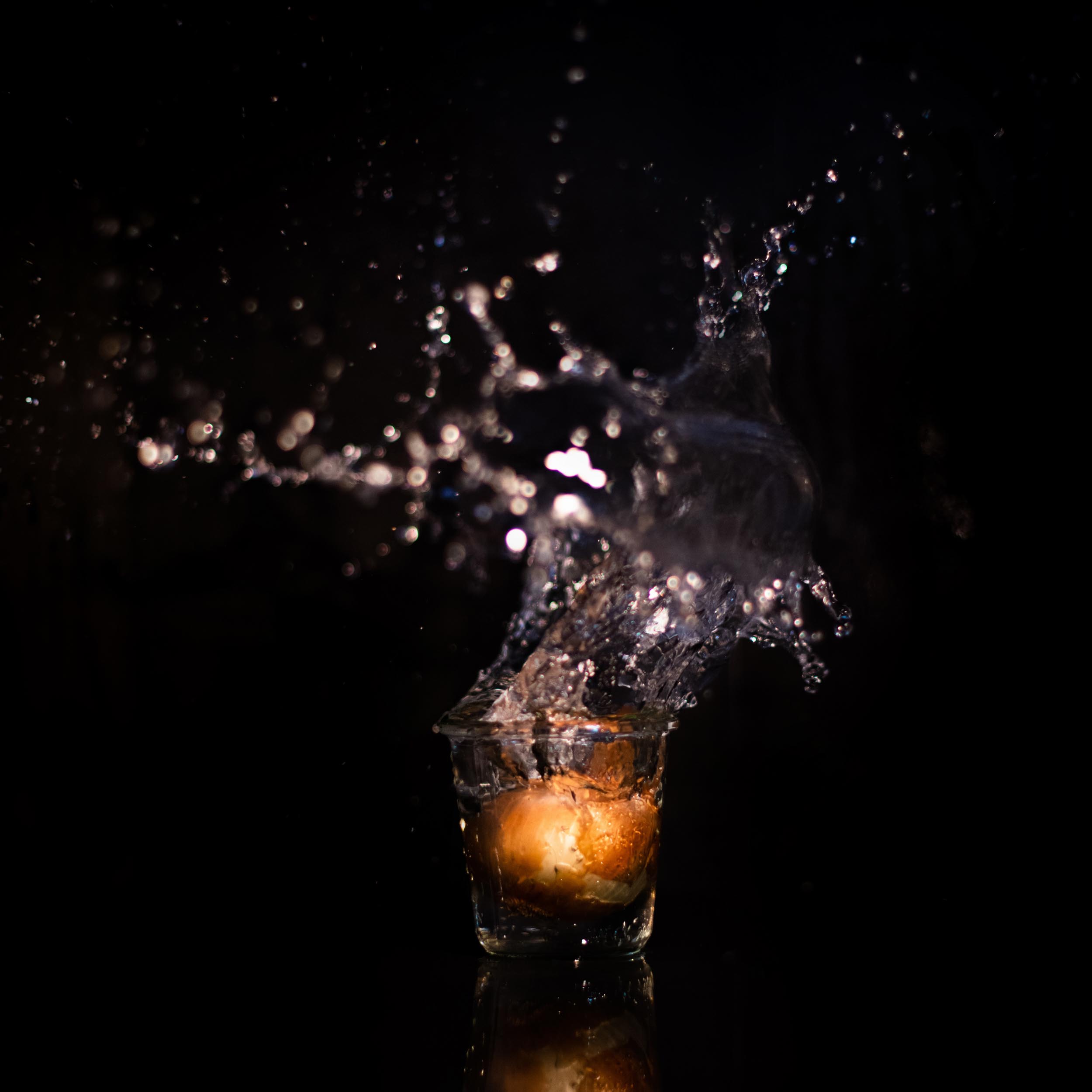 onion in a glass that splashes the water upwards