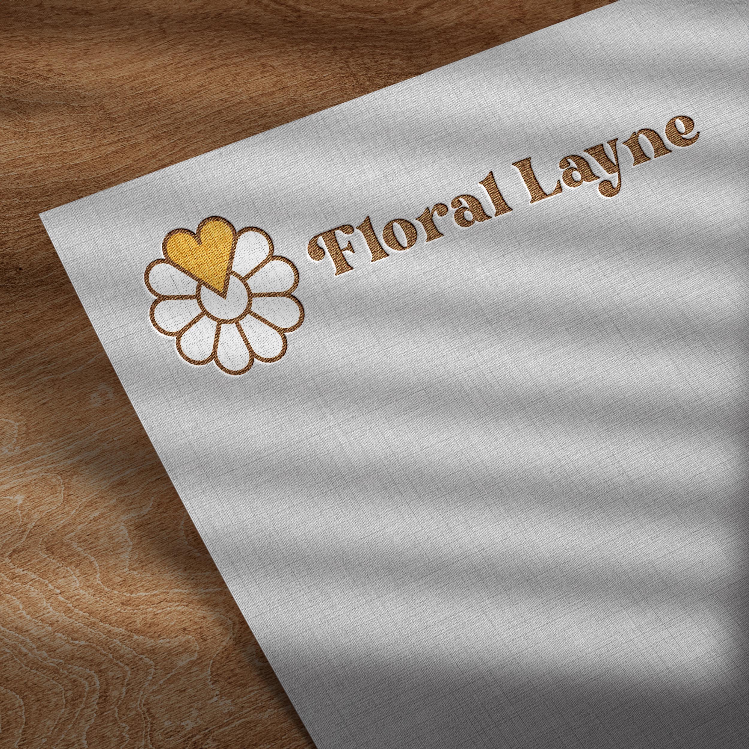 corner of a sheet of paper with an engraved logo displaying a flower consisting of multiple hearts